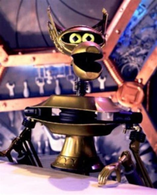 Crow T. Robot from the show Mystery Science Theater 3000. He's a gold robot resembling a skinned Big Bird.