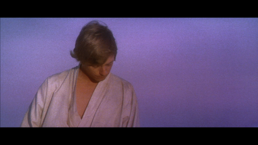 Luke Skywalker looks down as if in shame during a sunset on Tatooine.